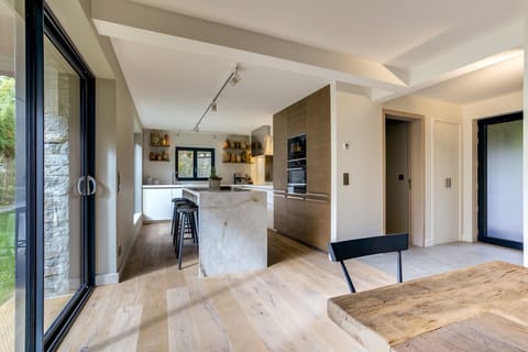 Kitchen with stone island with stools   