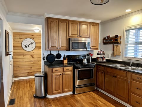 microwave, oven and stove including multiple cast iron skillets, pots, pans, etc