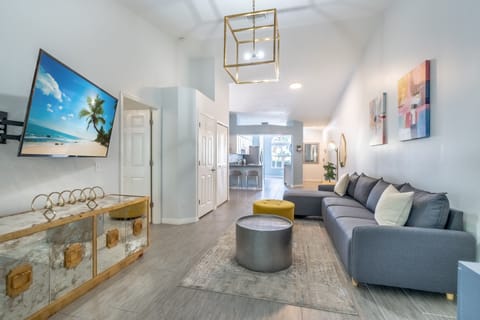Living room w/ exquisite modern furniture, decor and a 55” smart TV. 
