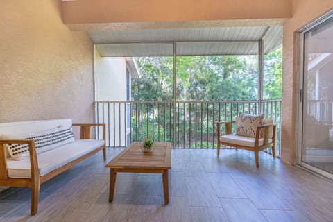 Private lanai w/ Italian tiles. Fully screened w/ modern wood furniture & decor.