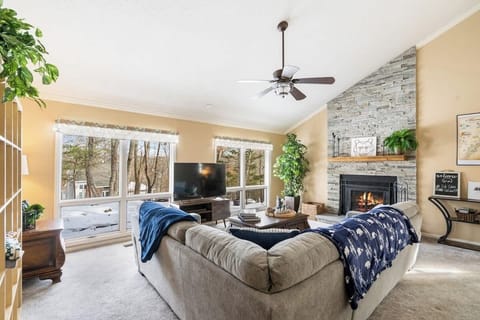 Main living room with wood burning fireplace and Roku smart TV.