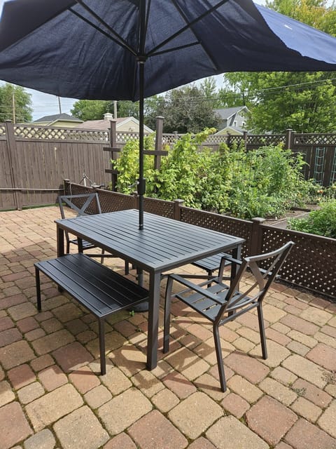 Relax on the back patio in the fully fenced in yard.