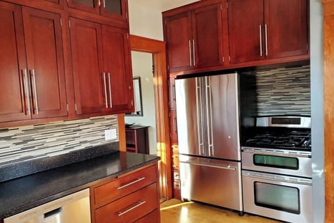 The Jenn-air refrigerator has built-in water, ice maker, and deli tray. Enjoy the provided beverages! The range has a smaller top over that's great for making pizzas.