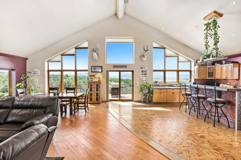 Enjoy extra high ceilings and windows in this kitchen, dining, and living area