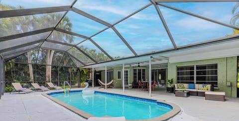 Spacious screened-in pool deck. Swim in 85°F waters & total privacy