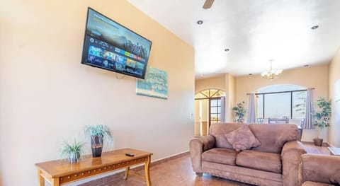 Relax in the living room and enjoy streaming on the Smart TV — a comfortable spot to wind down after a day at the beach.
