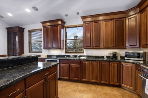 Your gourmet kitchen features rich cherry cabinetry, granite counters, and modern appliances—perfect for cooking memorable vacation meals. Unit A