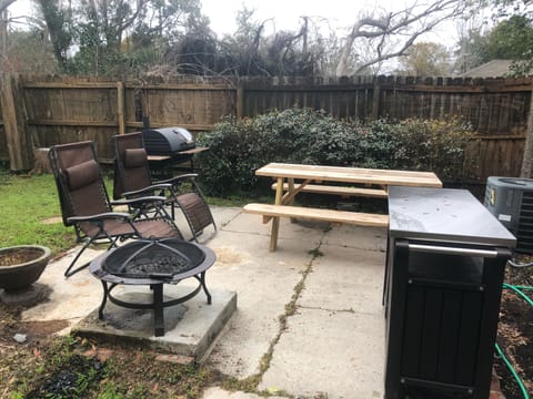 Back yard patio with fire pit and grill