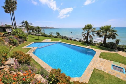 One of the swimming pools surrounded by gardens in this community by the beach