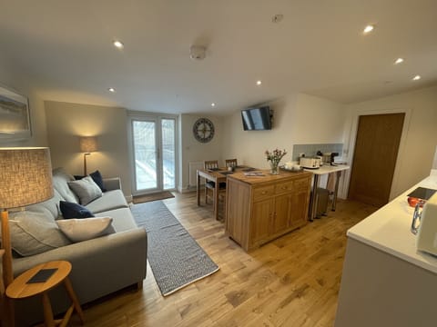 Open plan living with solid oak flooring & door to private enclosed patio garden