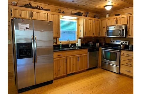 Fully equipped kitchen with stainless steel appliances and granite countertops