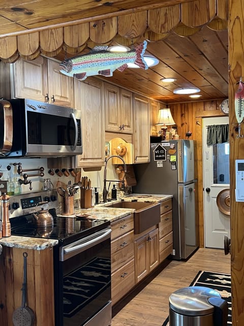 Kitchen workspace with Cook's Pot Filler Faucet and Hammered Copper Farm Sink