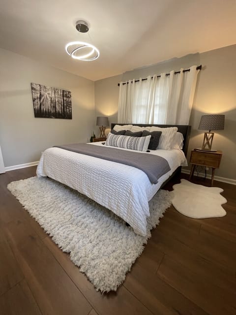 Lush master bedroom with adjoining half bath, blackout curtains, king bed 