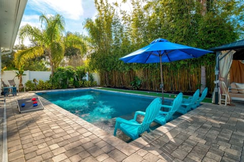Heated saltwater pool surrounded by lush landscaping
