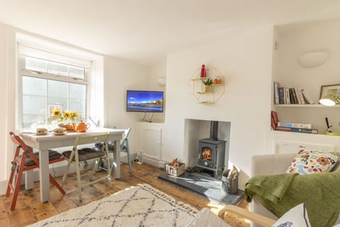 Cosy lounge and dining area centres around the welcoming log burner