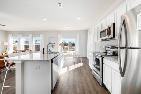 Our kitchen can be found to the right of the living room. It's fully stocked with all the cooking amenities you could ever need, including a drip coffee maker, high-end appliances and plenty of built-in storage.