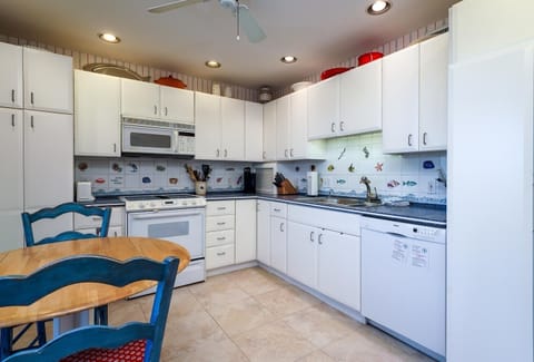 Fully furnished kitchen with seating area for conversation while cooking.