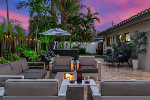 🔥 Unwind under the palm trees with wine by the fire — then sink away in the 7 person hot tub.