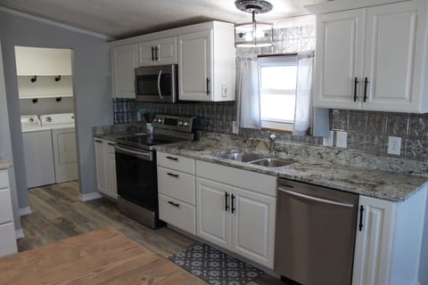 Kitchen is furnished with new stainless steel appliances and lots of storage