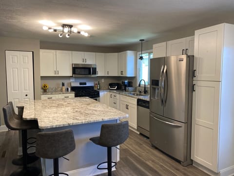 Kitchen with huge island with seating for 4.