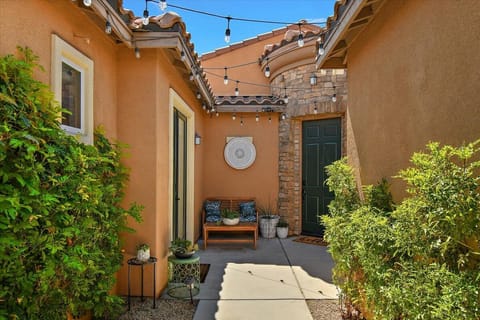 Courtyard with plants, seating. Main door and Casita door to the left.