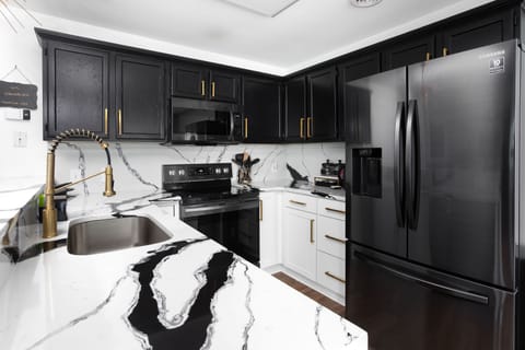 The NEWLY REMODELED Galley (kitchen) with dazzling quartz countertops
