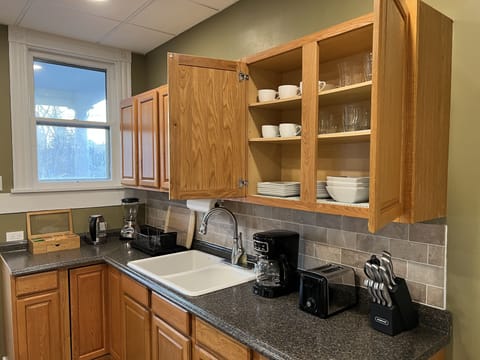 Kitchen Cabinet with plates, bowls, and cups.
