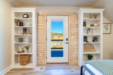 Bedroom showing outside door and balcony