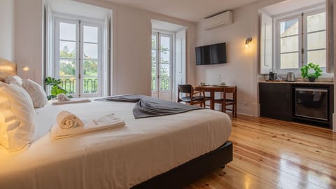 Gorgeous main area with a king size bed, a balcony and an AC unit #AC #spacious