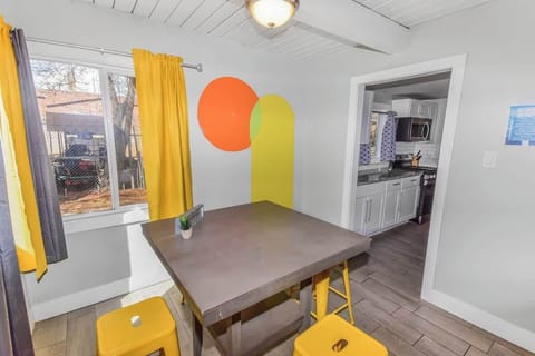 A vibrant dining nook with bold yellow accents, modern decor, and natural light, creating a cheerful and inviting space.