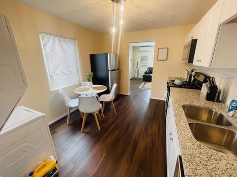 Fully stocked kitchen with washer and dryer.