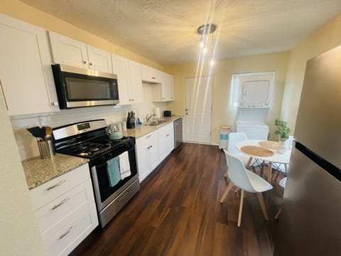 Fully stocked kitchen with washer and dryer.
