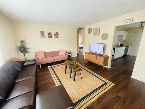 Living room with 42 inch smart TVs comfortable couch.