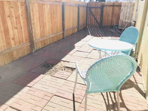 Backyard with two chairs to enjoy some sunshine or chill at the end of day.