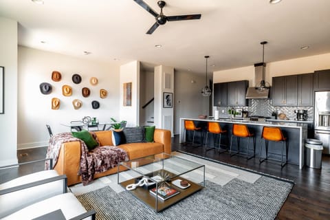 2nd Floor: Bright and open living room featuring a Smart TV,  Designer Furnishings and a dining room that seats 6 guests.