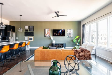 2nd Floor: Bright and open living room featuring a Smart TV,  Designer Furnishings and a dining room that seats 6 guests.