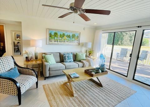Your bright living space opens onto a private deck, with tropical artwork and comfy seating for unwinding after exploring.