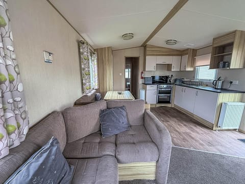 Cozy living room with open kitchen and natural light