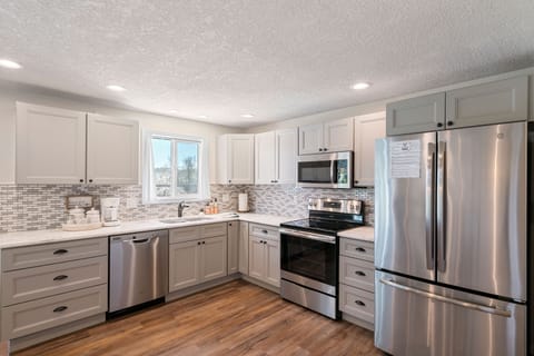 The kitchen is fully stocked with all cookware, dishes and utensils needed.