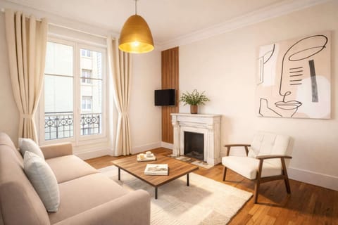 The living room features a double sofa bed, HD flat-screen TV, and free high-speed Wi-Fi.