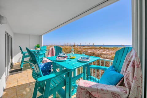 Dine gulf front on your private balcony with turquoise furniture and stunning sea views stretching to the horizon.