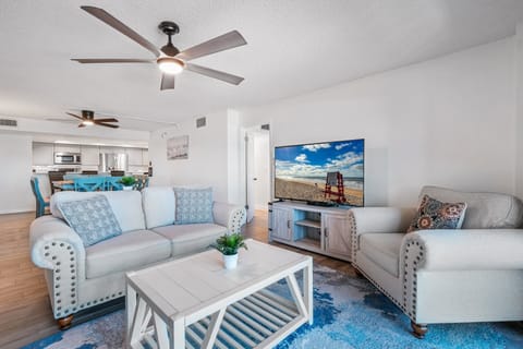 Relax on comfortable couches and watch your favorite shows on the large TV in the oceanfront living room with stunning beach views