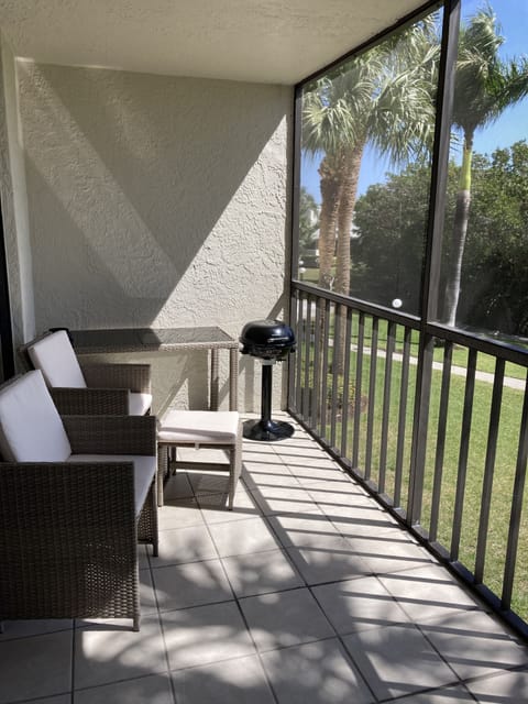 Screened lanai with outdoor furniture and electric grill
