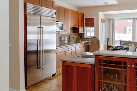 Kitchen with dishwasher, microwave and bar sink, drip coffee maker.