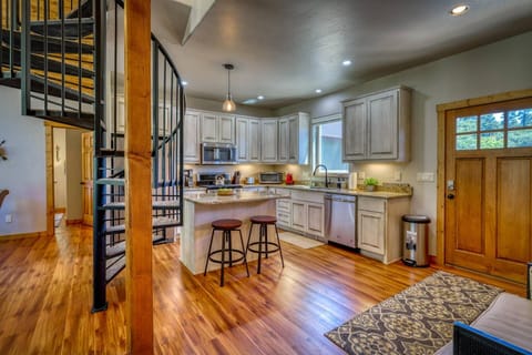 The kitchen features stainless steel appliances, granite countertops, and an island perfect for chatting while cooking.