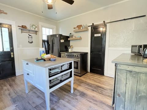 Kitchen with high end gas stove, new refrigerator and walk-in pantry.