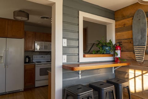 Sitting area by back door and laundry room with washer, dryer, detergent, etc.