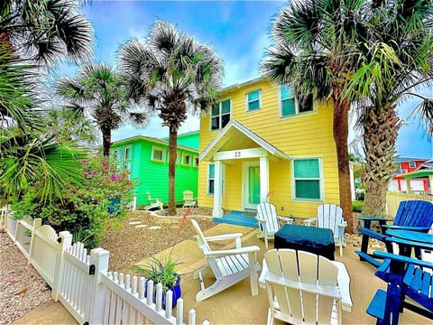 Colorful exterior and outdoor seating — welcome to your Village Walk getaway.