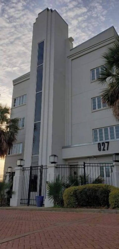 Landmark Art Deco building with secured gate around building and parking