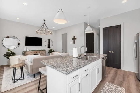 Kitchen with island stocked with pots, pans, and utensils